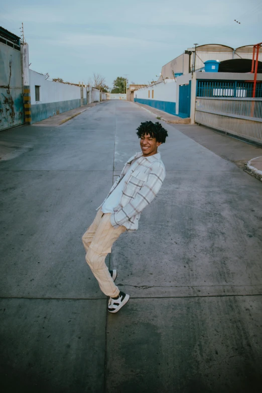 a boy doing skateboard tricks in a parking lot