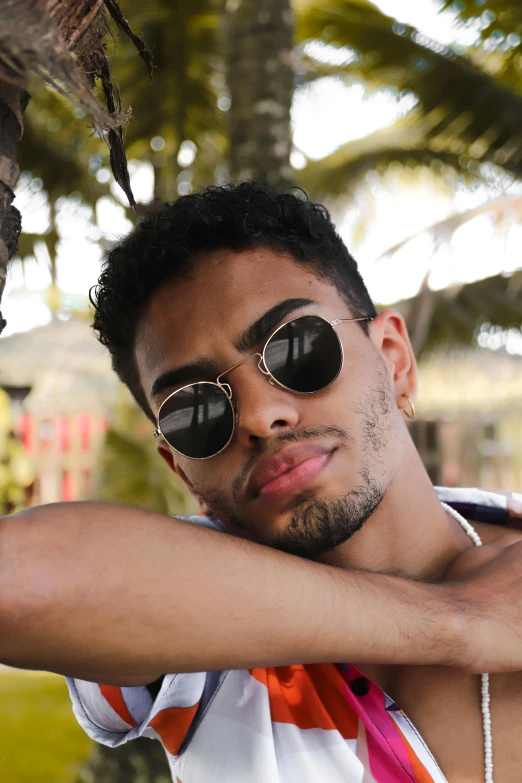 a man that is wearing sunglasses that is sitting