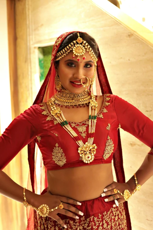 beautiful indian woman dressed in gold and red