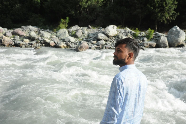 a man looks at soing over rough water