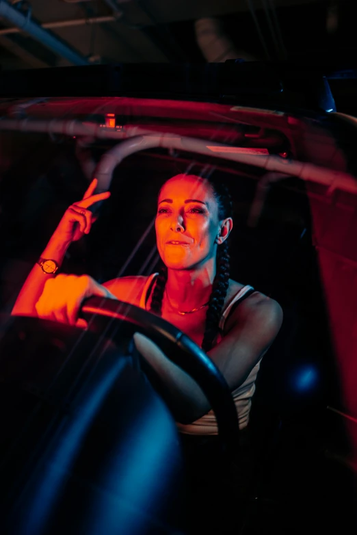 a woman sitting in the driver seat of a car