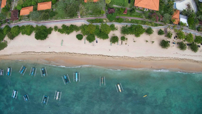 a beautiful beach with sail boats on the ocean