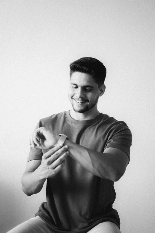 a man sitting down on a toilet holding an apple