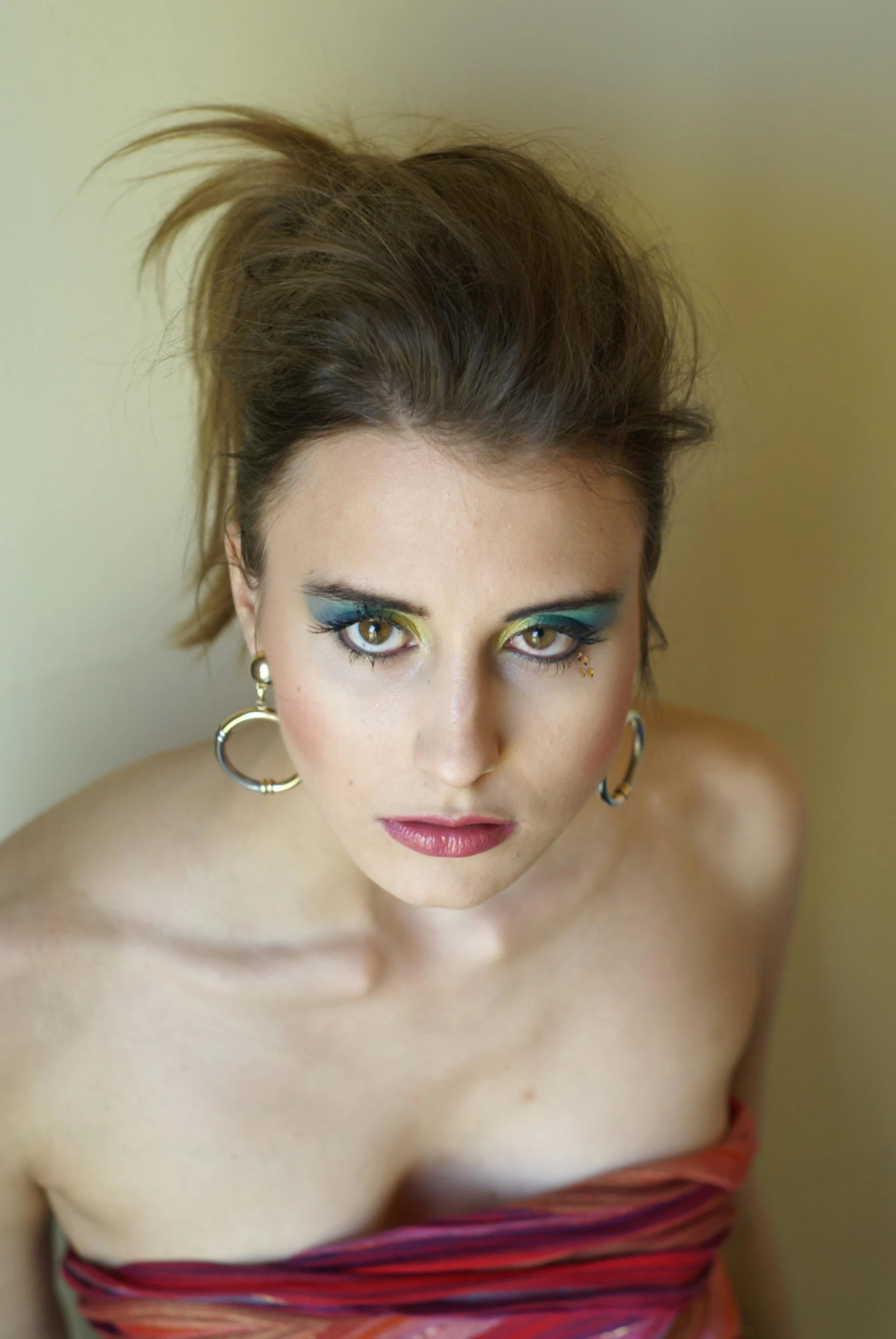 woman with freckles and jewelry posing for pograph