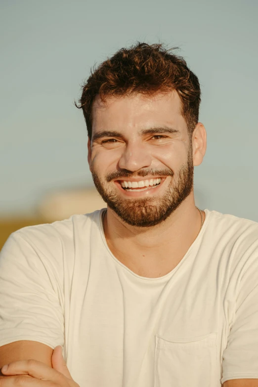 a man with a beard wearing a white shirt