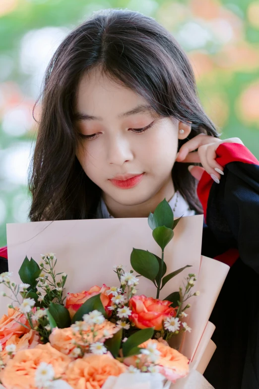 woman with face down holding bouquet of flowers