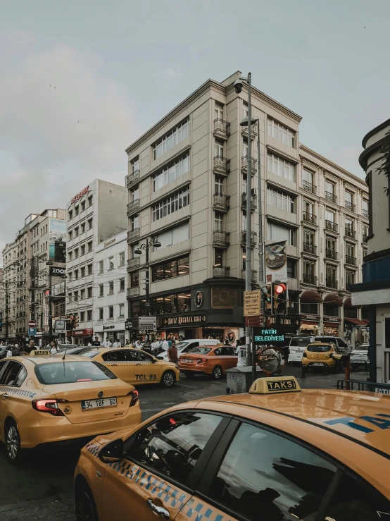 cars are driving down the road in a city