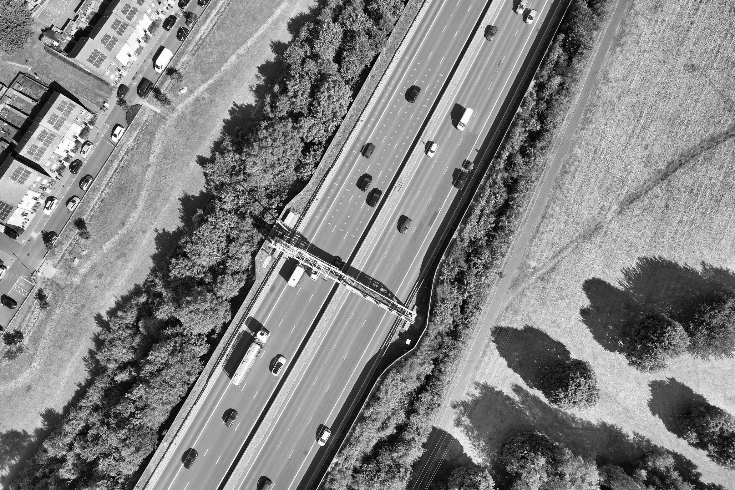 an aerial view of a country road and buildings