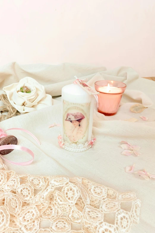 a candle on a lace tablecloth next to a pair of decorative beads