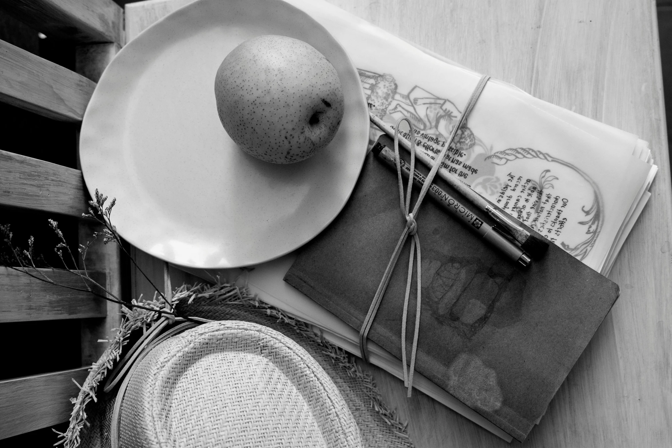 some book and a plate on a wooden table