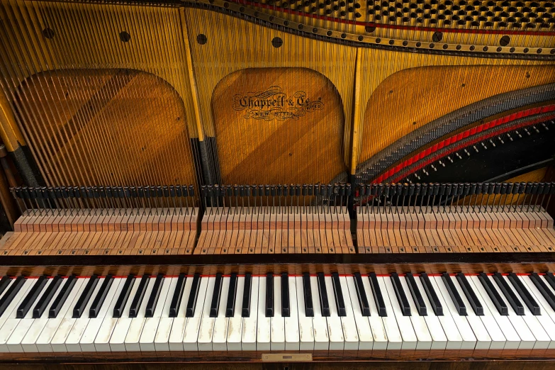 the upright piano sits next to a colorful piece of art