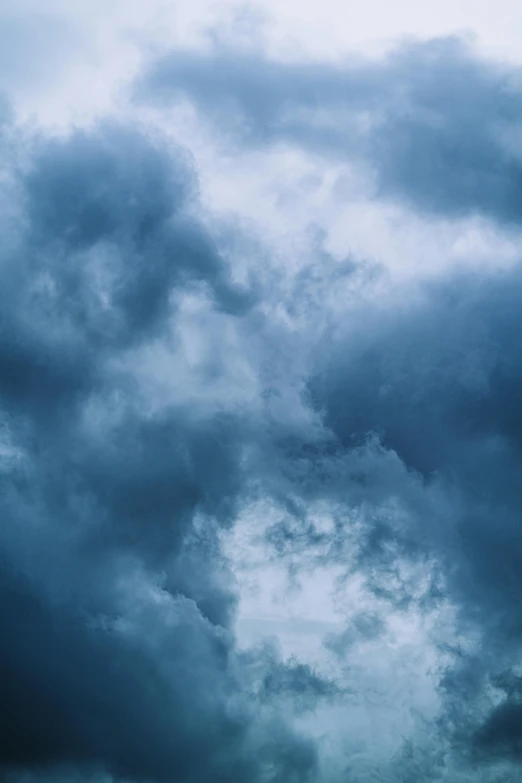 a big pretty airplane flying through some cloudy skies