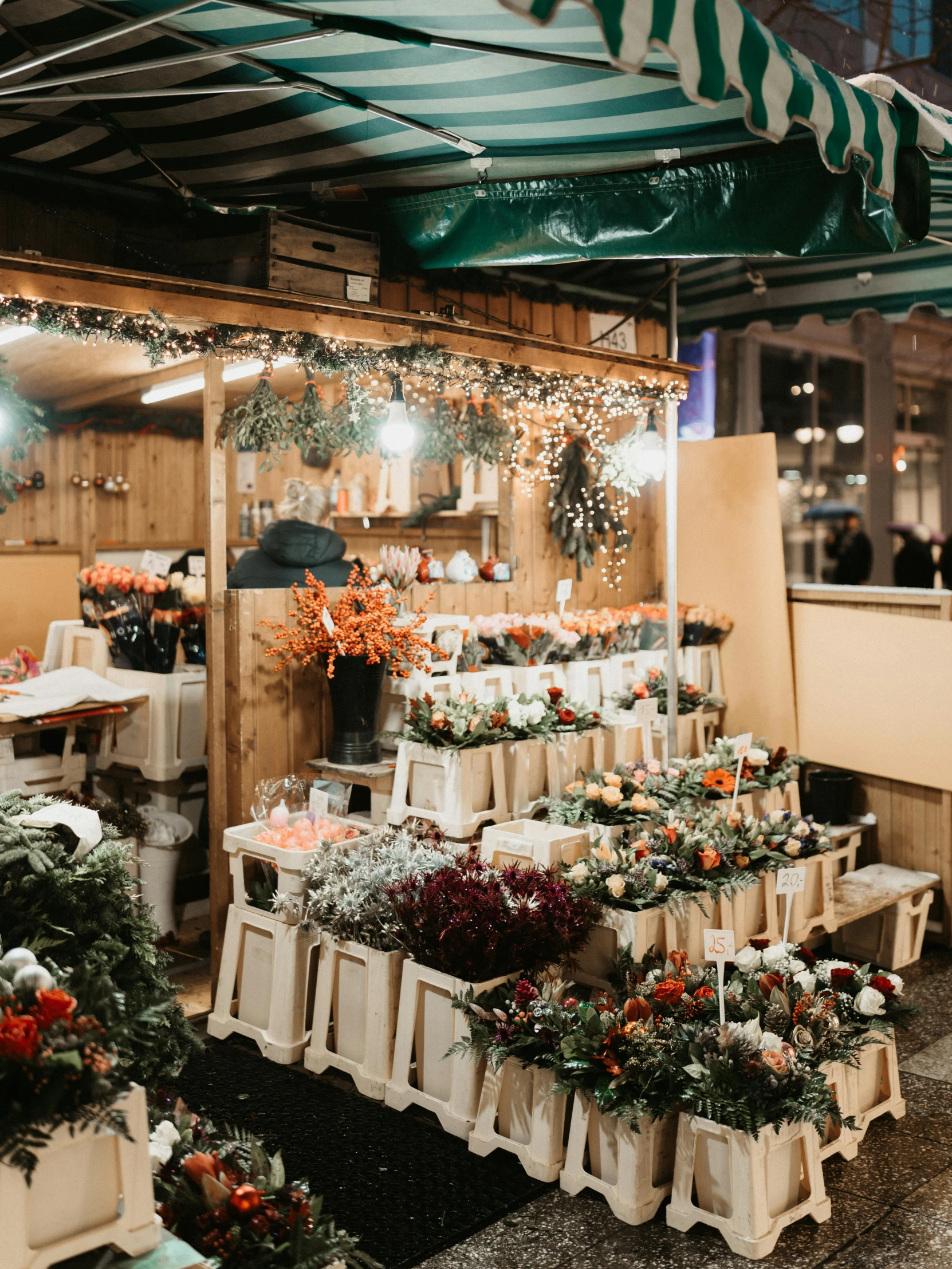 a shop with potted flowers in it sitting inside of a building