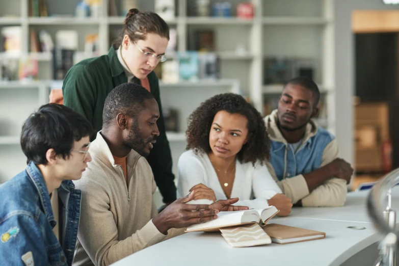 a group of people gathered around a table in a liry