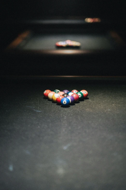 three plastic balls of different colors lying in the middle of a floor