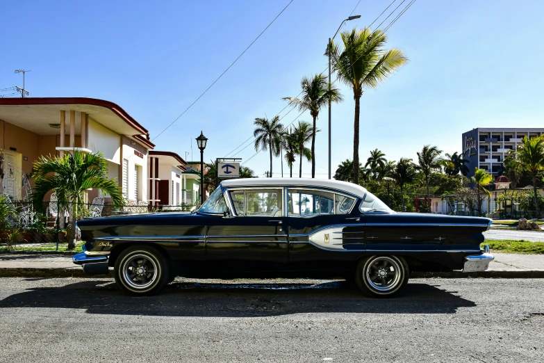 an older fashioned car is parked in the street