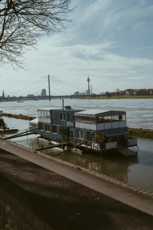 a boat sits docked on the bank of a river