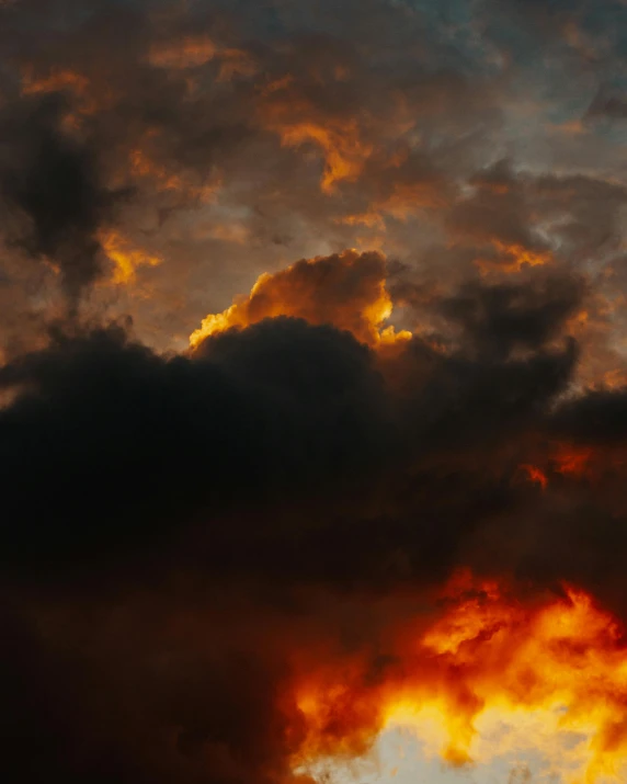 a plane in the distance against a cloudy sunset