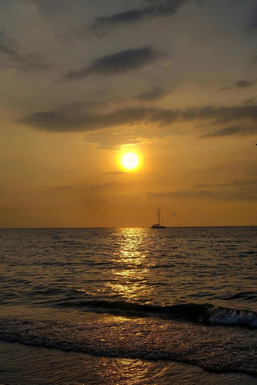 a bright sun setting over a very big body of water