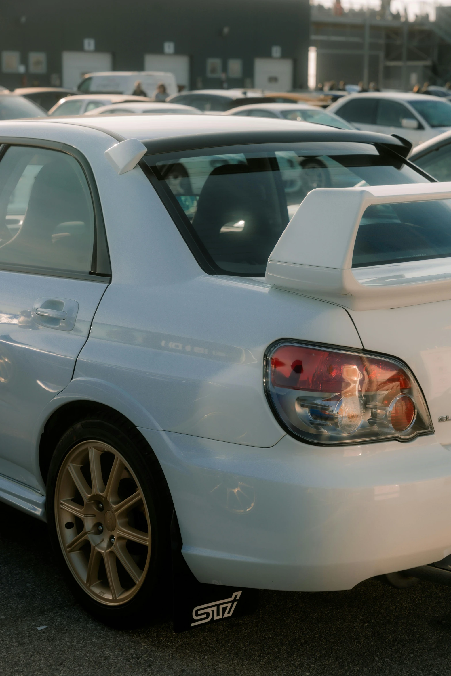 a white car parked in front of a parking lot