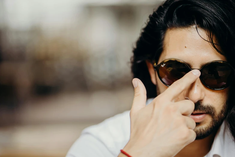 a man in sunglasses with long hair and a goatee