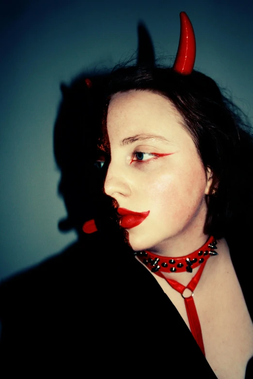 an artistic po of a woman wearing devil horns