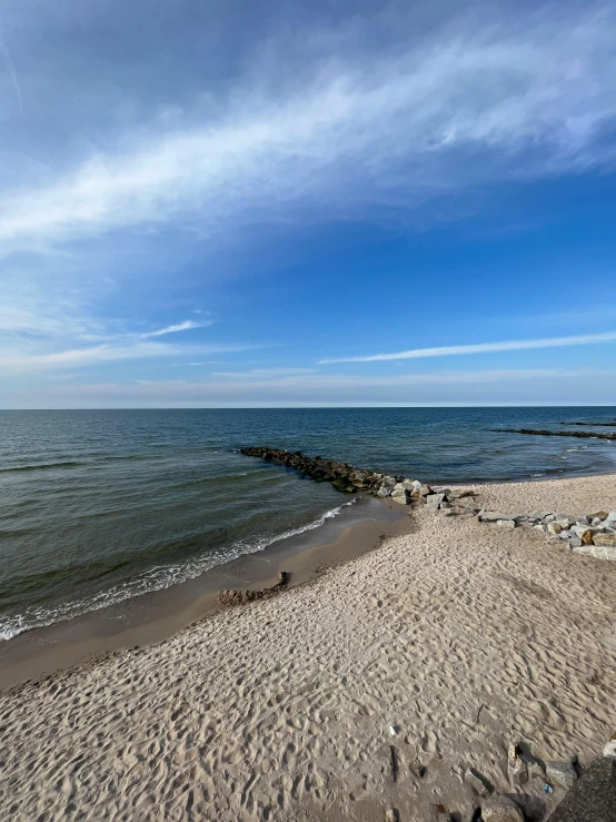 a white sandy beach and some blue water