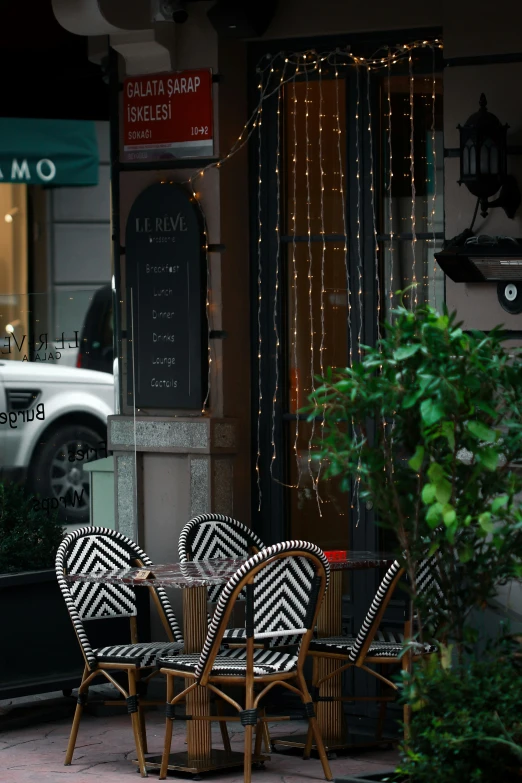 several empty chairs are in the front of a cafe