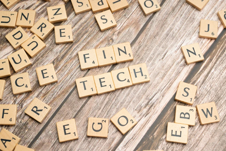 a bunch of small wooden blocks spelling fun tech