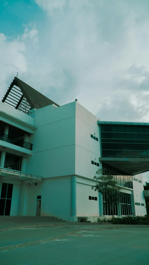 a view of a large building under a cloudy sky