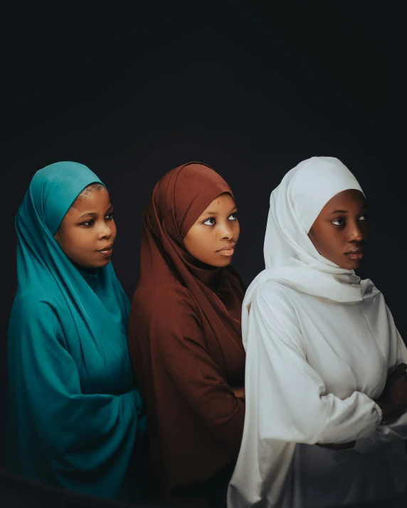 a group of three women in long hies