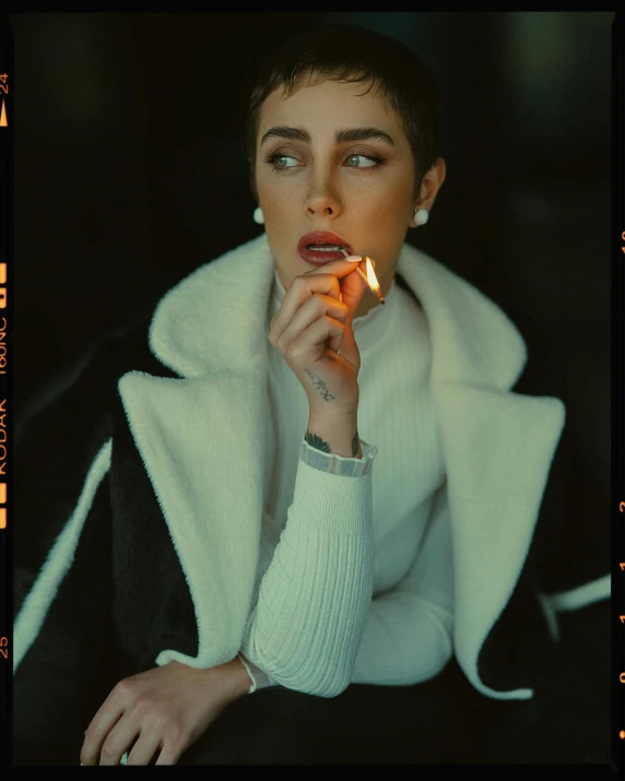 a woman in white is smoking a cigarette