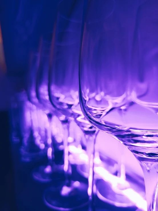 several clear wine glasses on the table