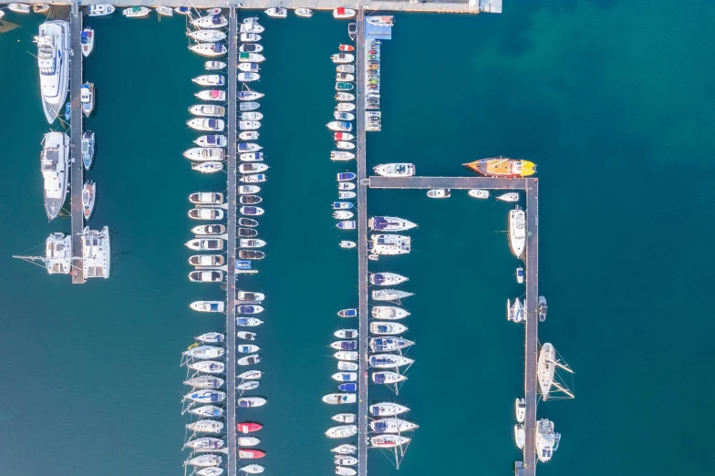 a pier with boats parked on it next to other boats