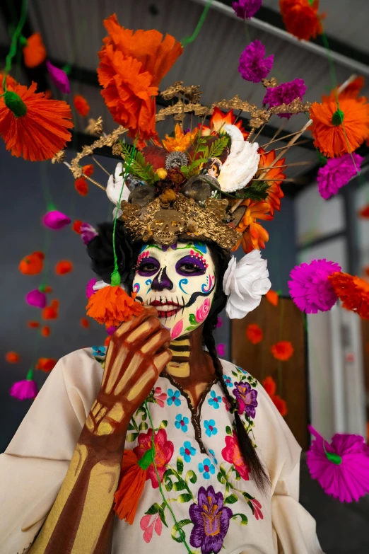 a skeleton is wearing a costume of flowers and oranges