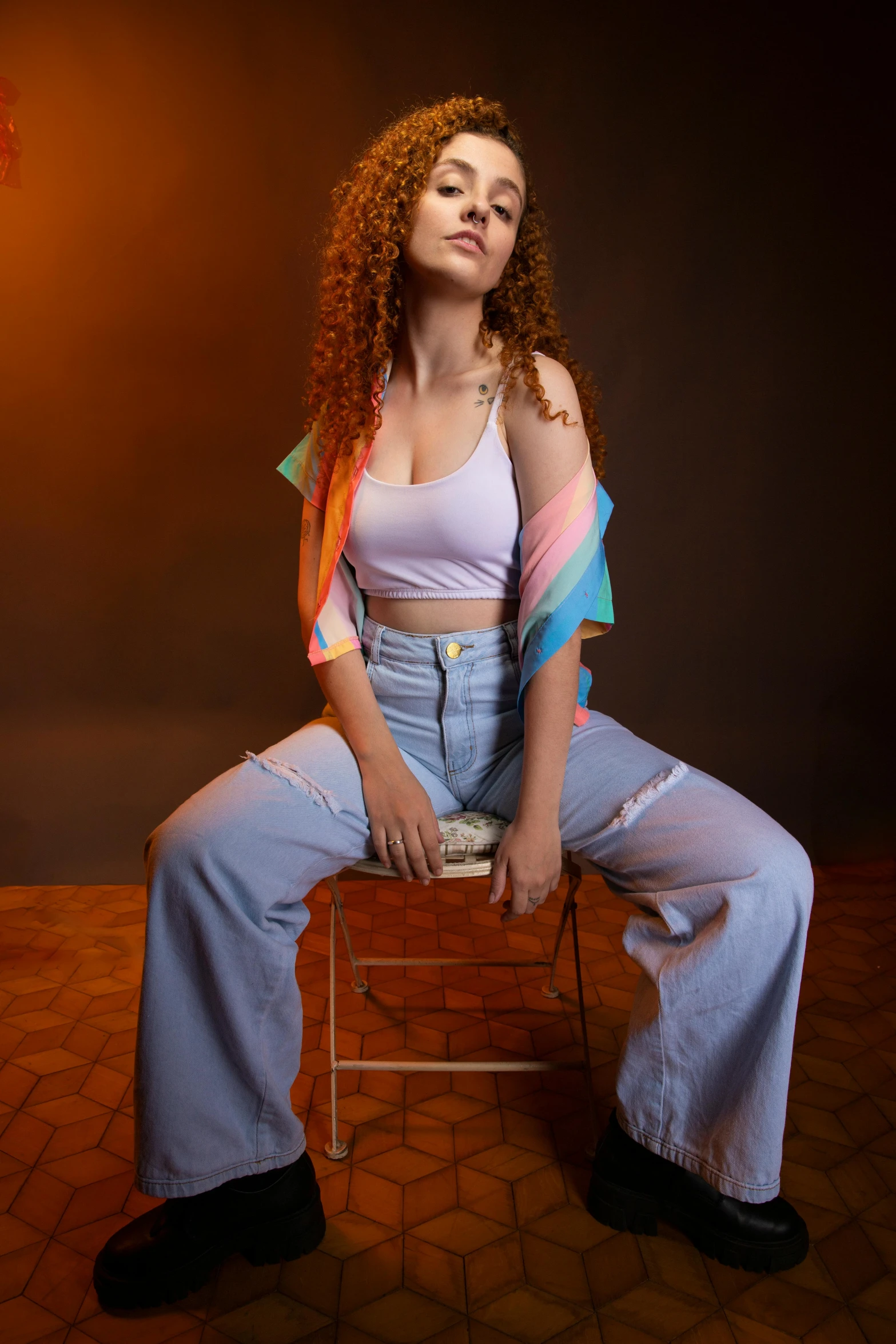 woman sitting on a stool in jeans