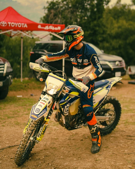 man in helmet and blue jersey riding a dirt bike