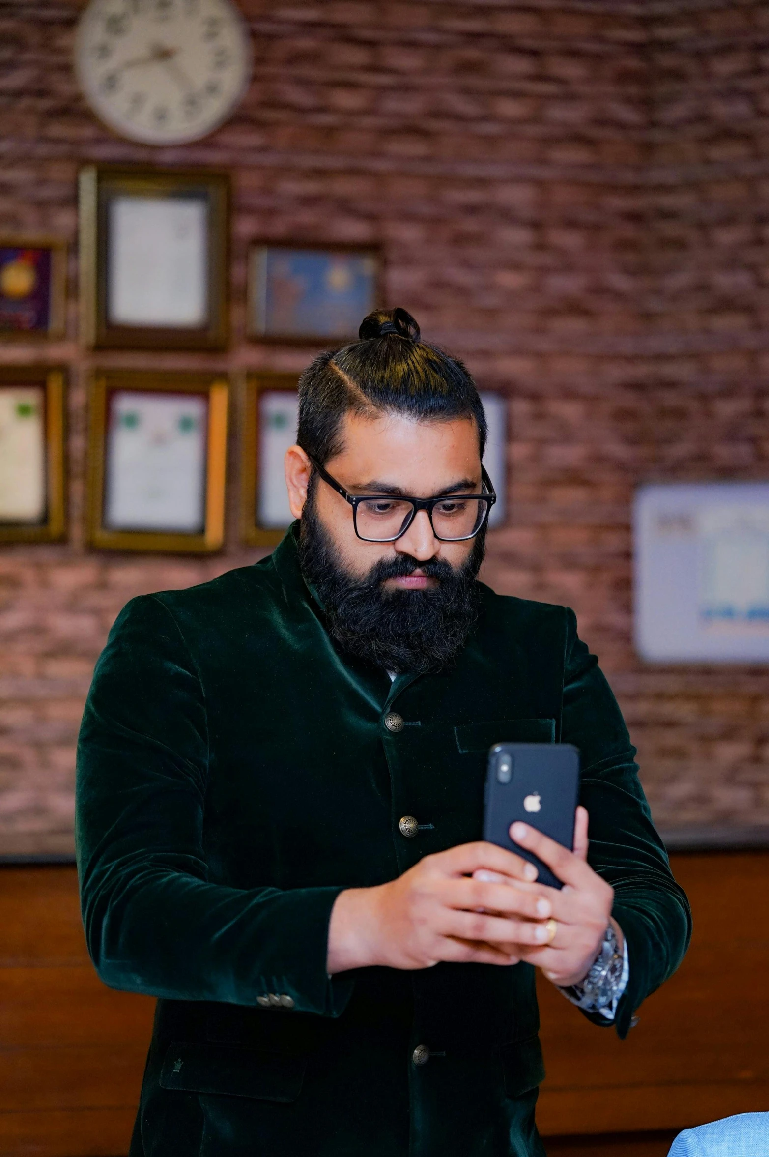 a man with a beard is using his phone