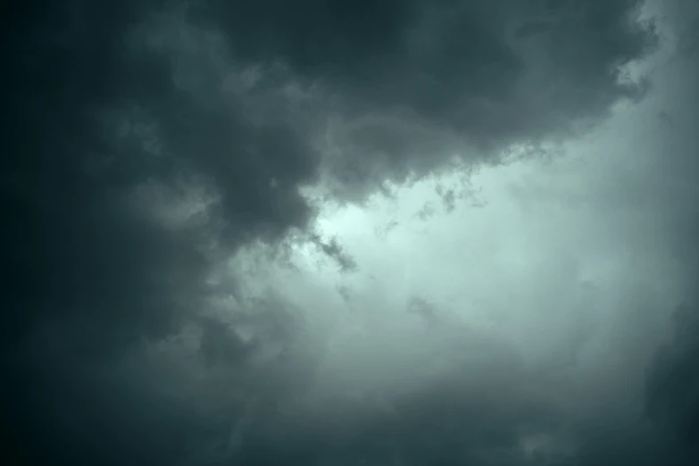 a dark cloudy sky with two planes flying