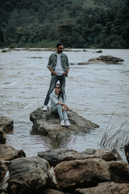 a man is standing on the rocks next to his friend