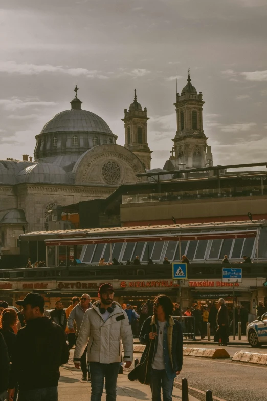 people walking around outside of an old building