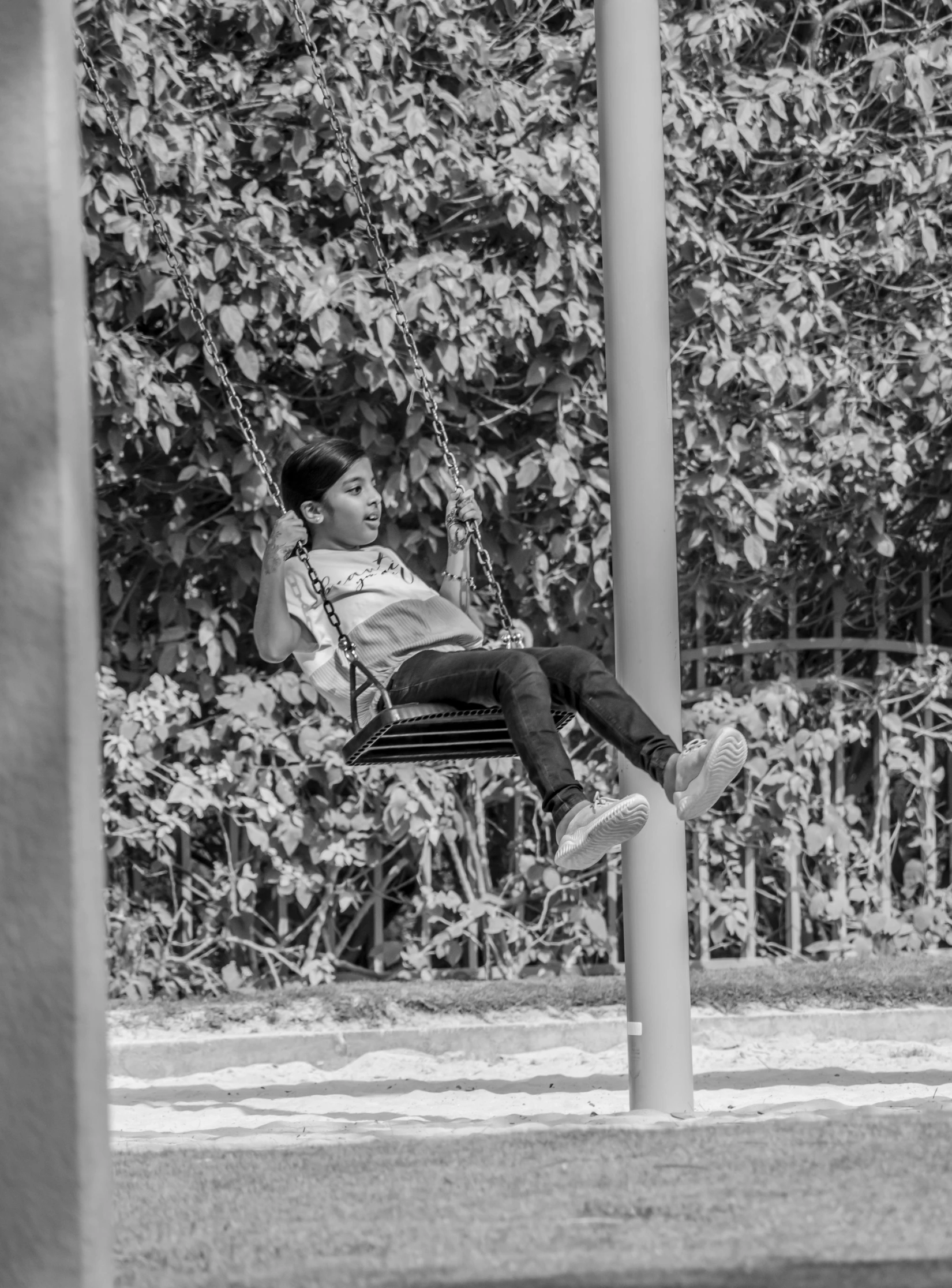 a little boy sitting on a hammock swing with his feet in the air