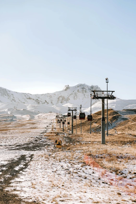 this train is crossing the snowy road and tracks