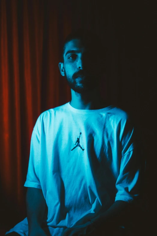 a man standing in front of a red curtain