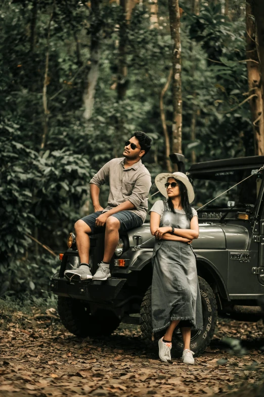 two people are sitting in a truck in the woods