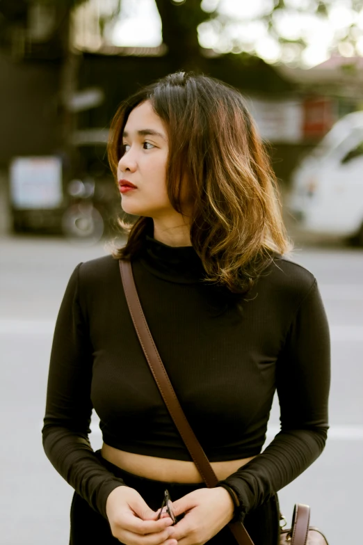 a woman with shoulder bag and black shirt