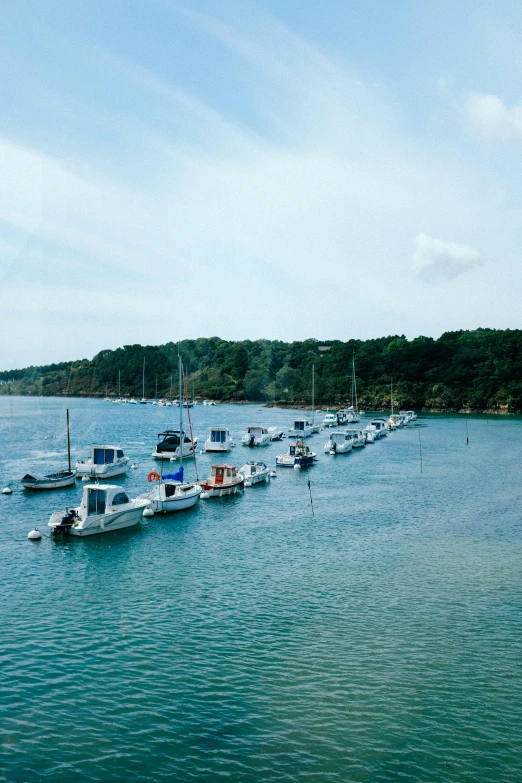 several boats anchored in the middle of the ocean