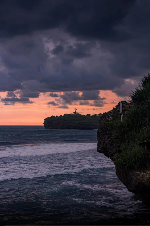 sunset view over the ocean with an island in the background