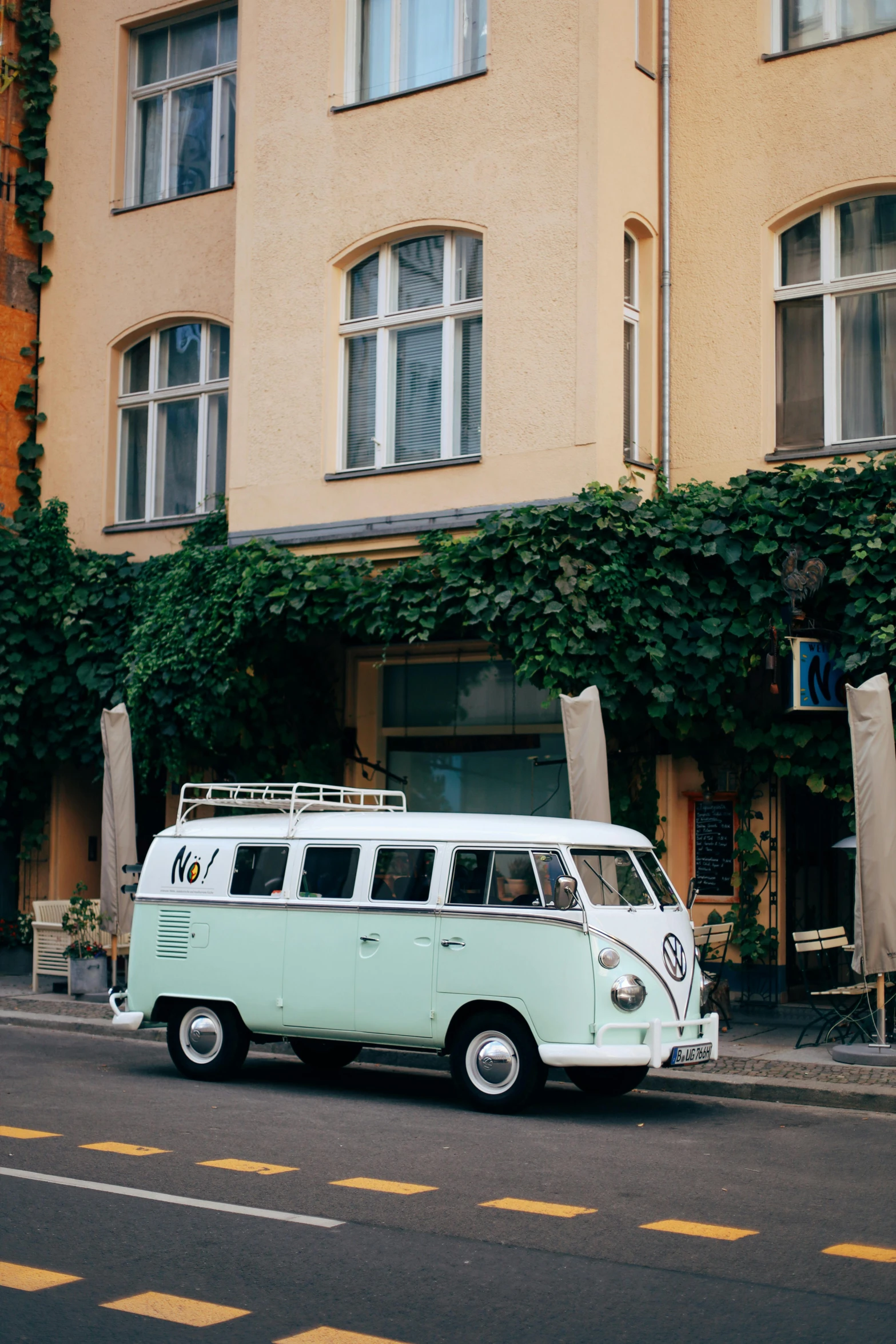 an old fashioned vw van parked in front of some old houses