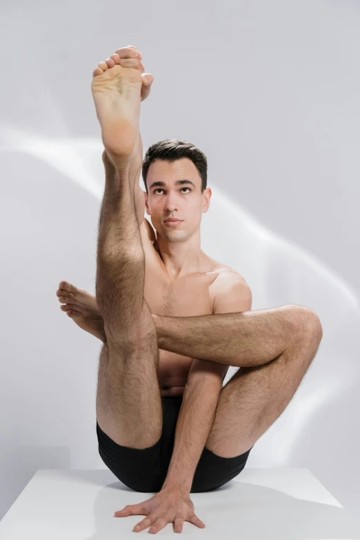 a young man posing on a surface with his 